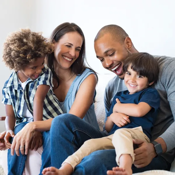 Family sitting on couch looking at each other