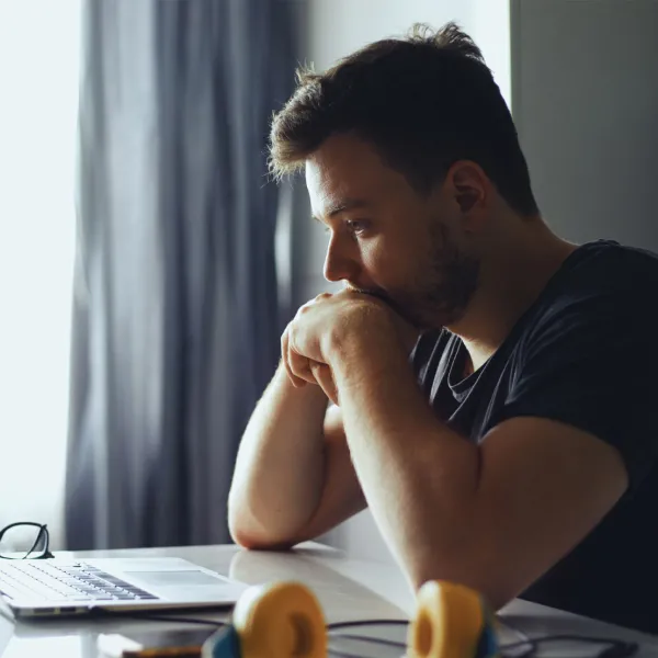 Man looking down at computer