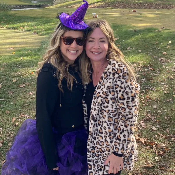 Two women dressed up for Halloween on a golf course