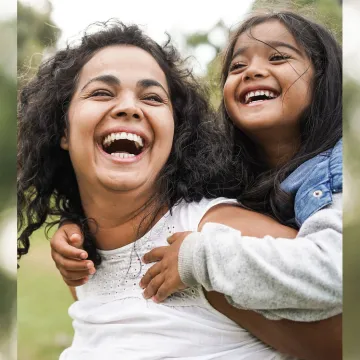 Daughter on moms back laughing