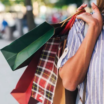 woman holding multiple shopping bags 