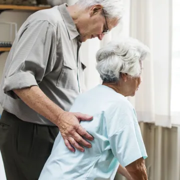 Elderly couple looking out a window