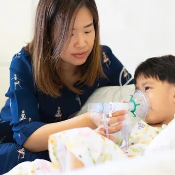 Mom helping her son breathe