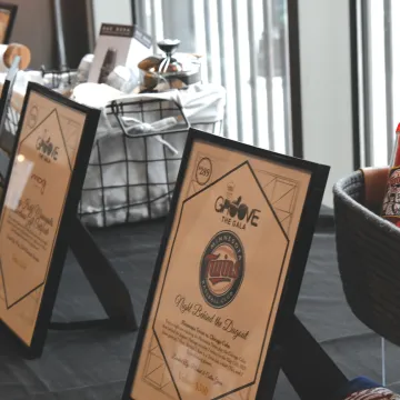 Silent auction items and signs on a table