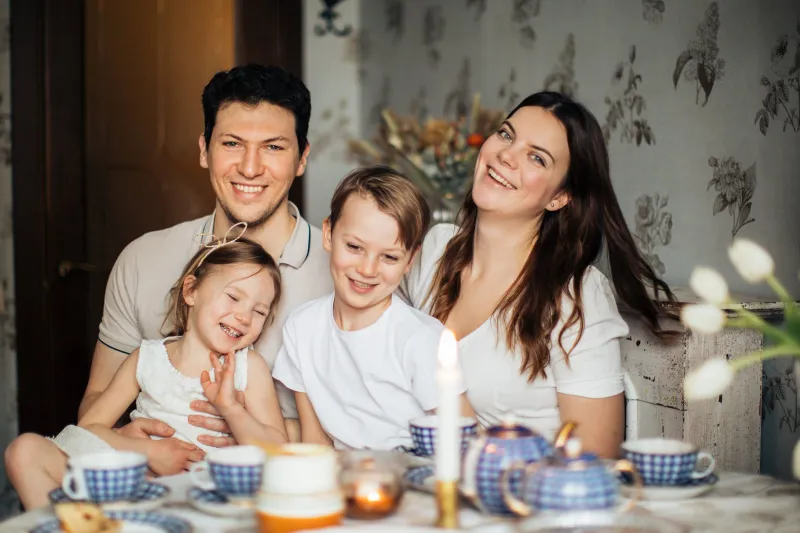 Family of four at a kitchen table